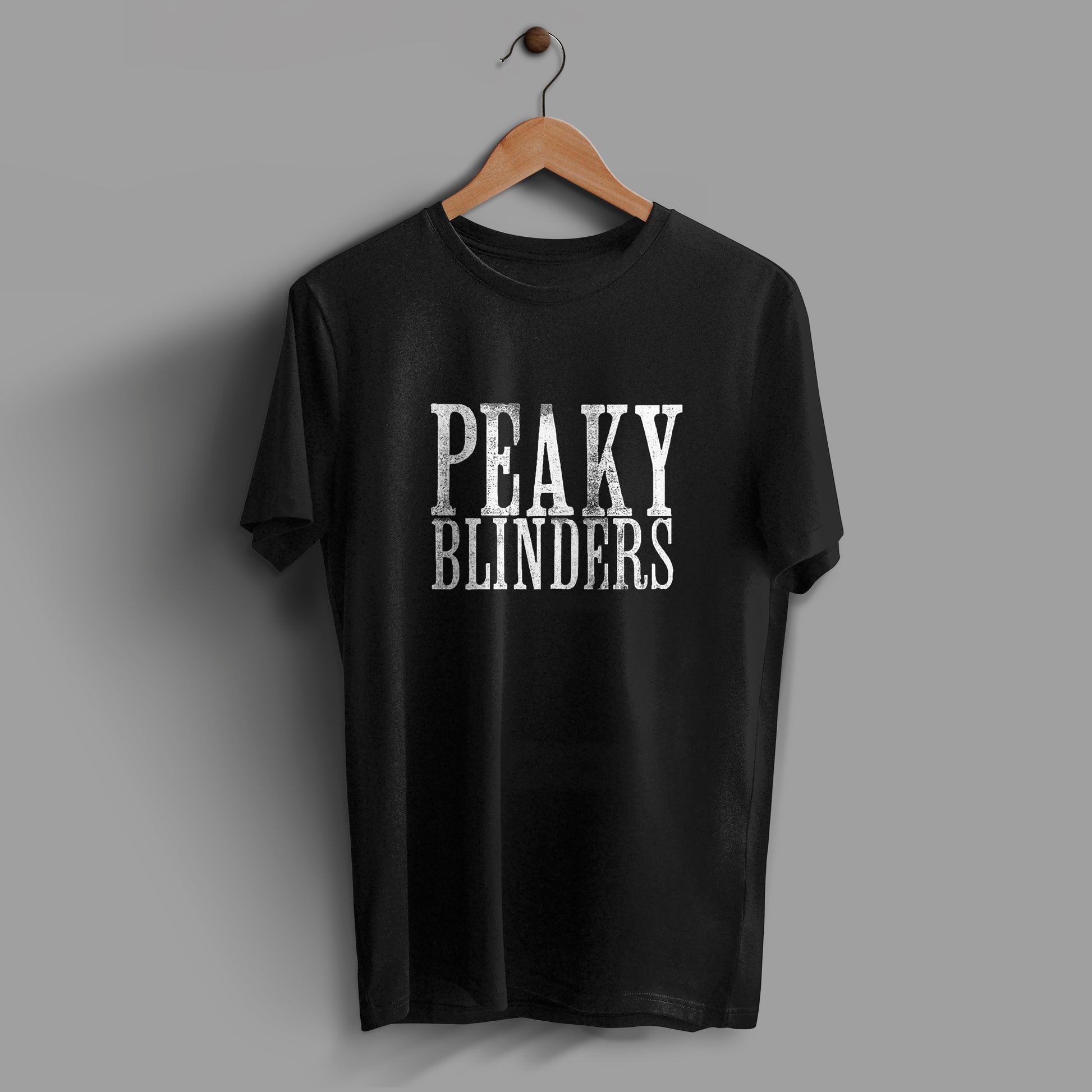 Black t-shirt with the text "Peaky Blinders" printed in white on the center of the t-shirt.