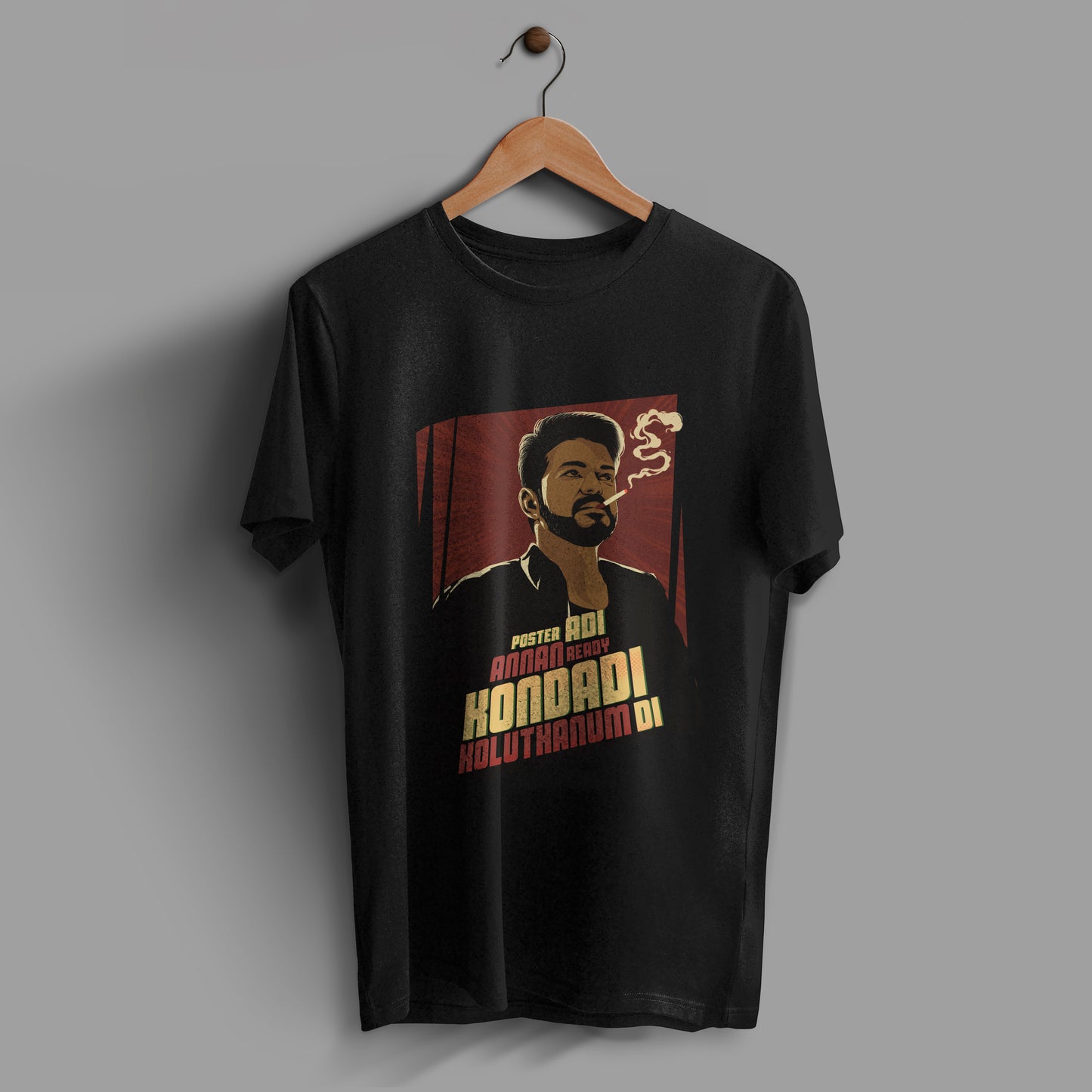 Black t-shirt with a picture of Thalapathy Vijay smoking a cigarette.And there is also a line from naa ready song "Poster adi annan ready, kondadi koluthanum di" is written on the t-shirt. The design is placed on the center of the tshirt.